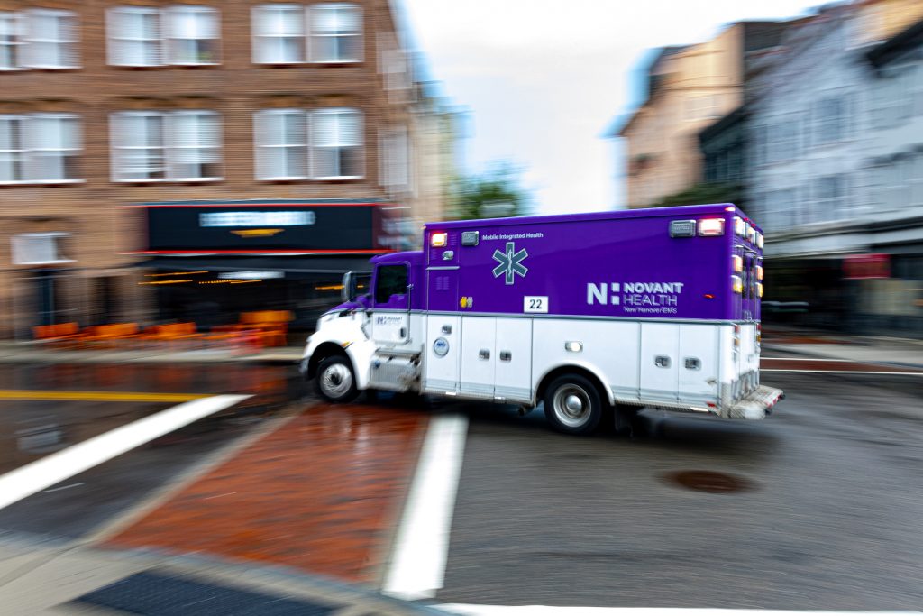 An ambulance rounds the corner of Front and Grace Streets in downtown Wilmington, NC.