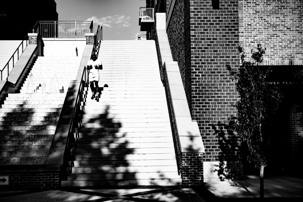 A man jogs down the stairs from Bijou Park down to Water Street in downtown Wilmington, NC.
