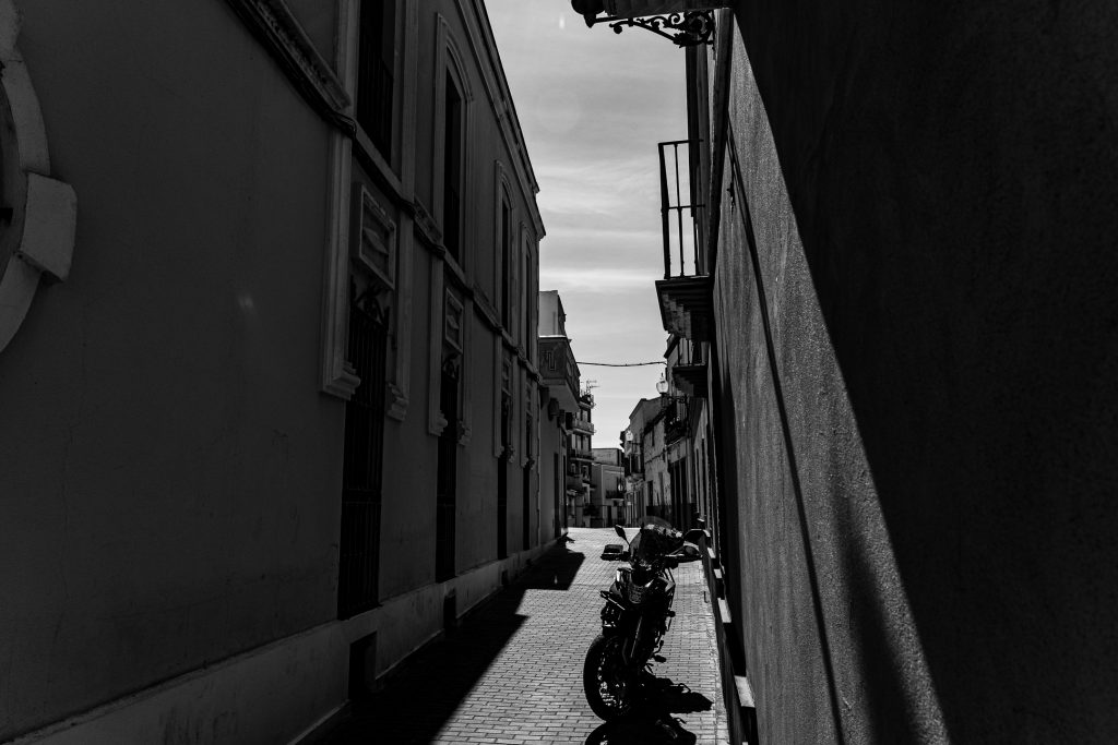 Black and white edit of a shot looking down a Calle Baños in Merida, Spain.
