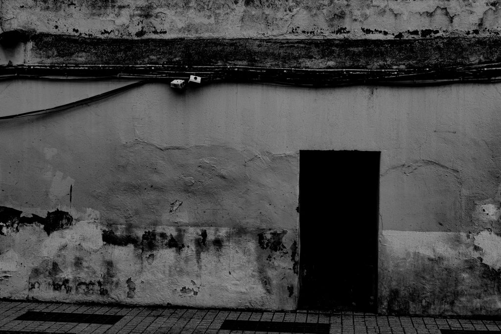 A door in the wall along a street in Mérida, Spain.