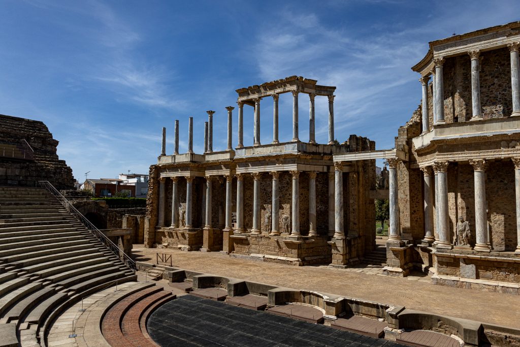 Viewing the stage and the columns and statues behind it at the Roman theater in Mérida, Spain.