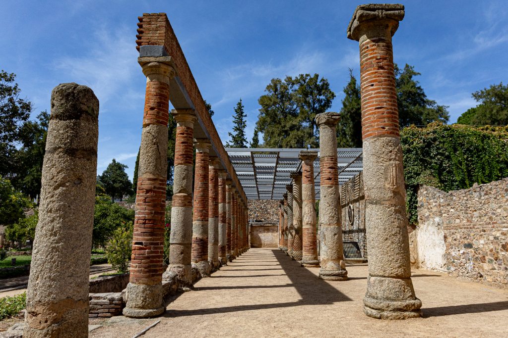 Ancient columns line the walkway of the ornamental gardens near the Roman theater.