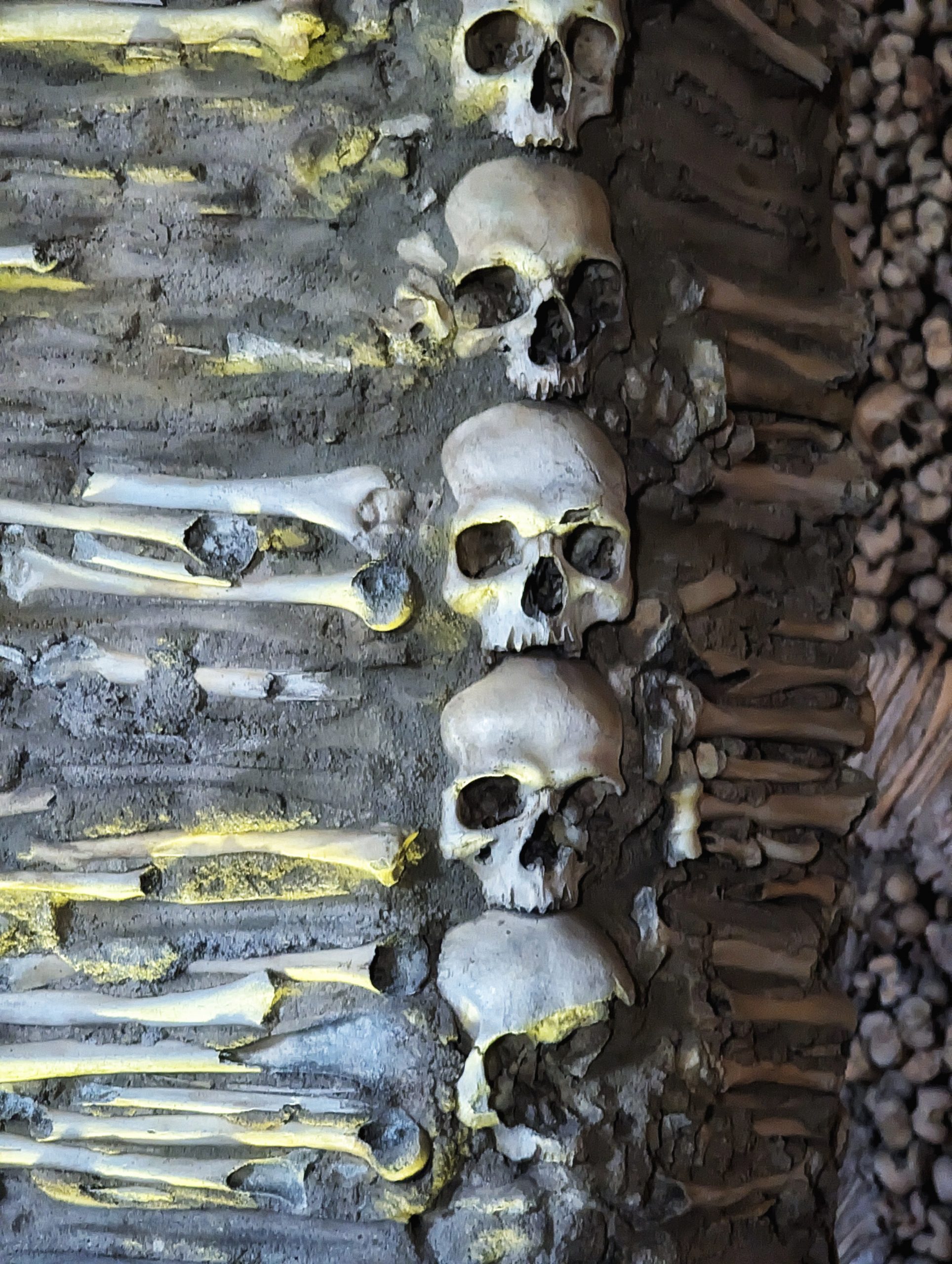 Bones and skulls on the column of a nave in the Capela dos Ossos, or Chapel of Bones, in Évora, Portugal.